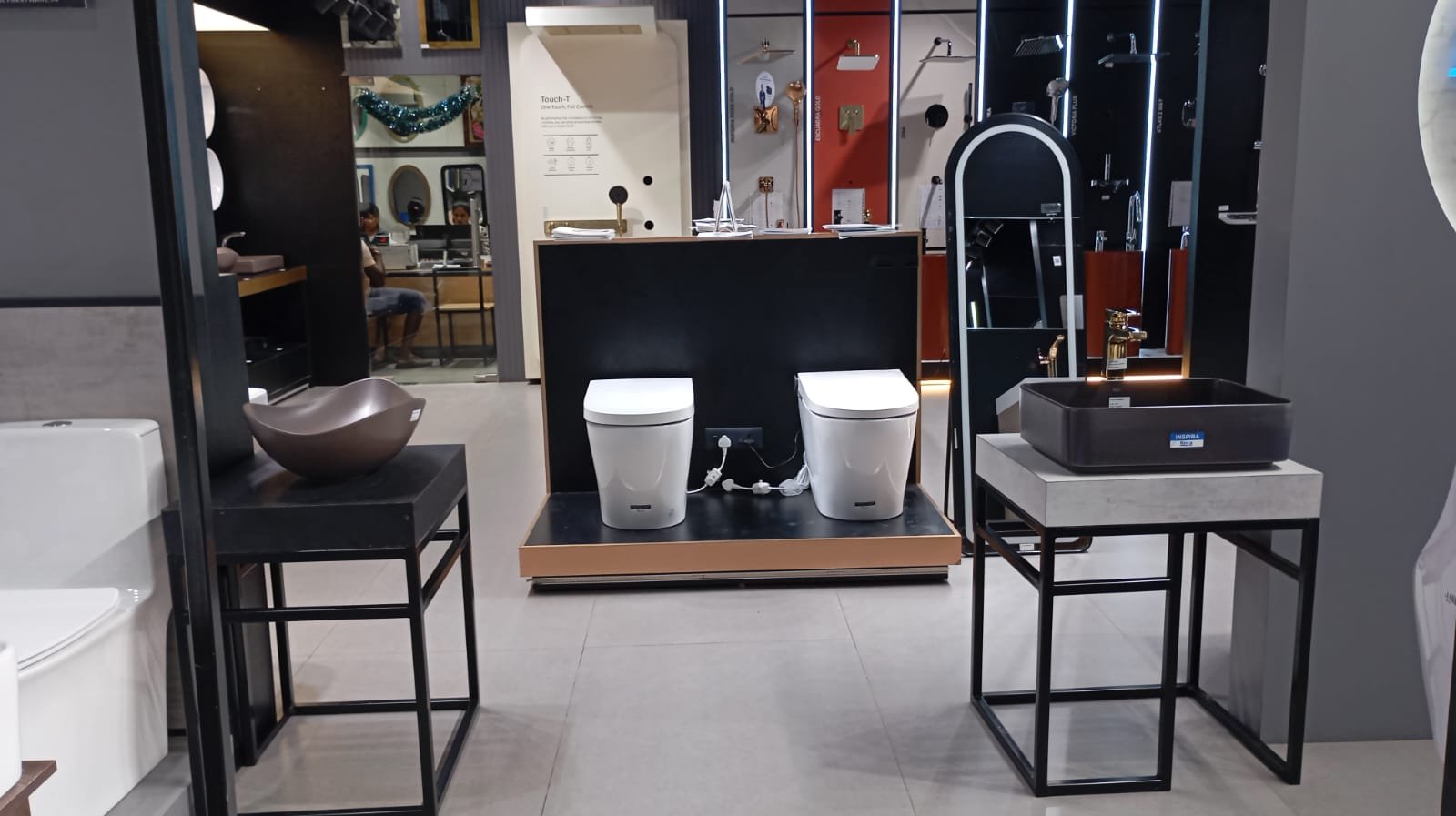 Sanitaryware display with toilets, wash basins and shower panels at the Devaki Ceramics showroom