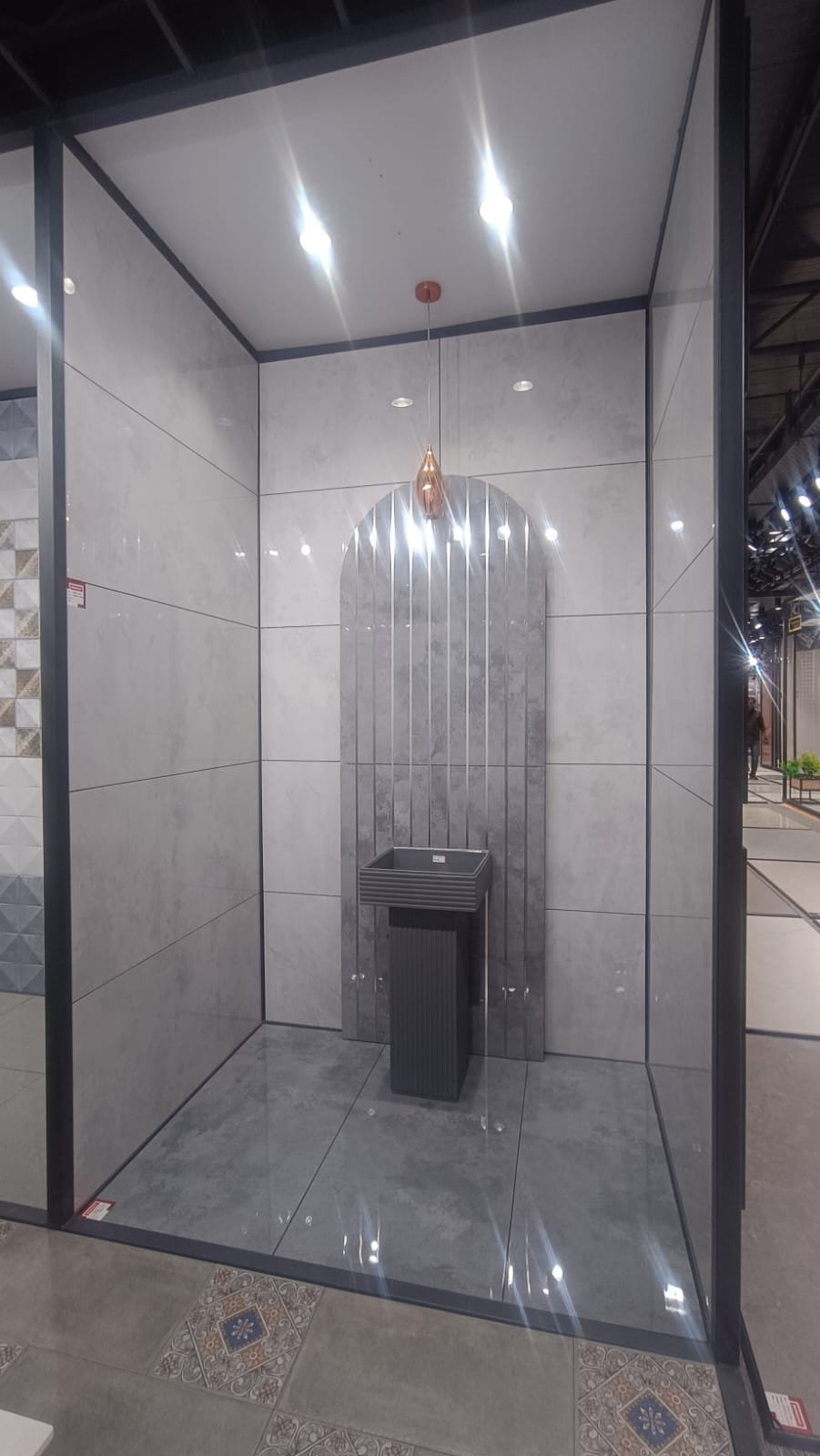Grey marble-look tile vignette with pedestal wash basin