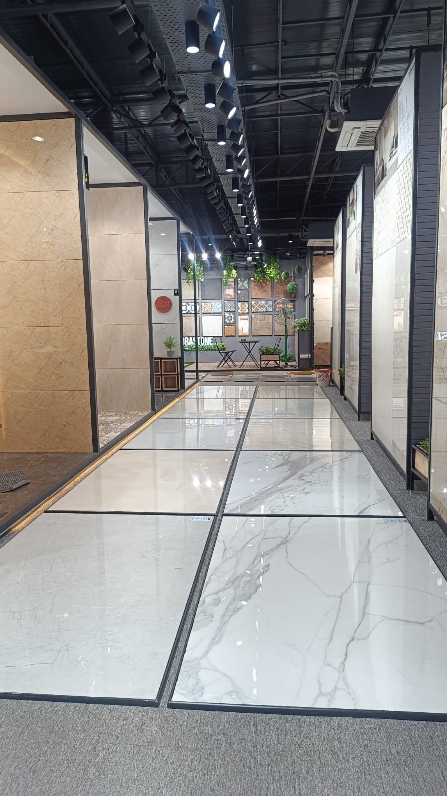 Wide marble tile display corridor at Devaki Ceramics showroom